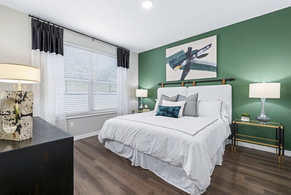 Modern bedroom featuring sleek design and ample natural light in Atlantic Springs Apartments
