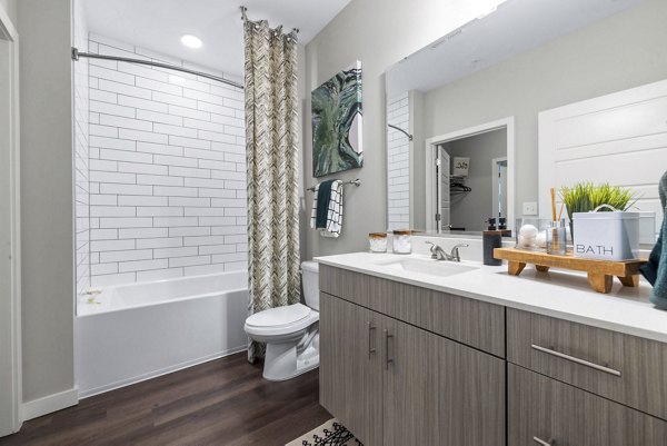 Atlantic Springs Apartments: Modern bathroom with sleek fixtures and bright lighting in luxury apartment community
