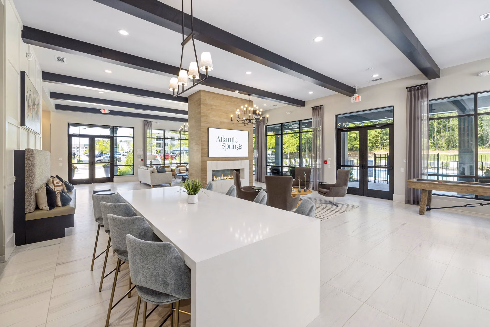 Clubhouse: Elegant event space at Atlantic Springs Apartments with modern furnishings and ambient lighting