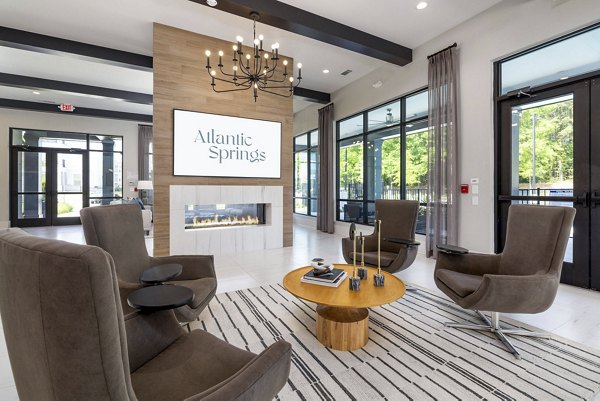 Contemporary clubhouse featuring modern furnishings and vibrant decor at Atlantic Springs Apartments
