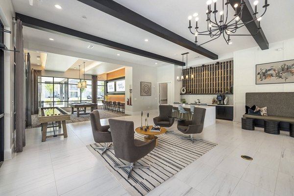 Clubhouse with modern decor at Atlantic Springs Apartments, featuring cozy lounge areas and entertainment options