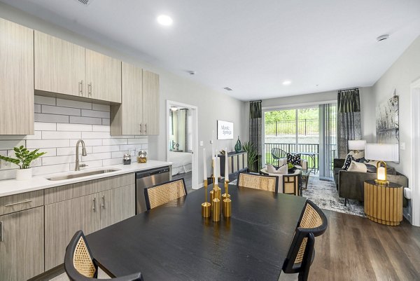 Open concept kitchen and dining room with modern appliances at Atlantic Springs Apartments