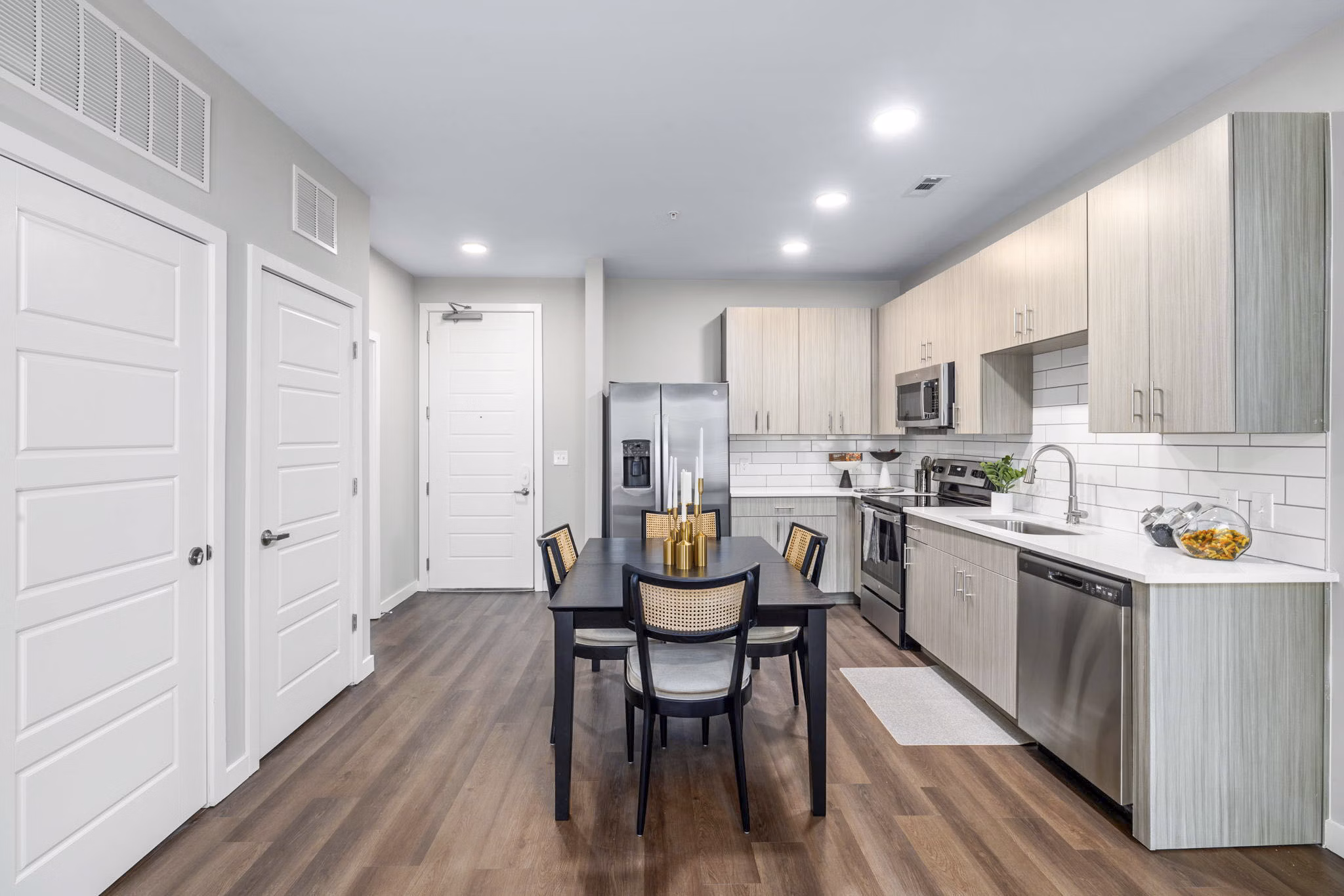 Open kitchen and dining room with modern appliances and elegant decor at Atlantic Springs Apartments, Greystar luxury community