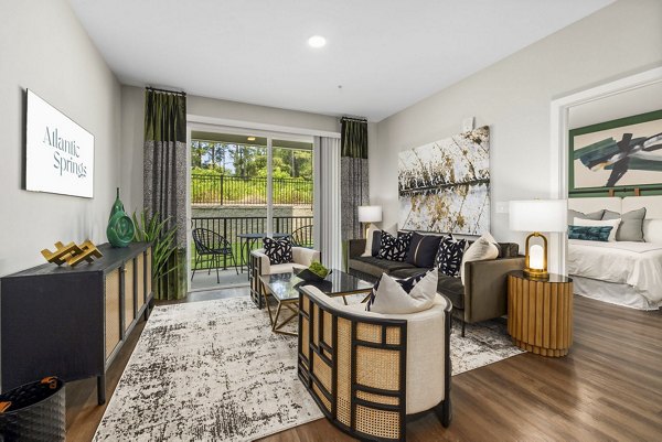 Atlantic Springs Apartments: Elegant living room featuring contemporary furnishings and ample natural light