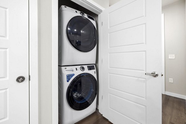 Laundry room featuring modern washers and dryers at Atlantic Springs Apartments