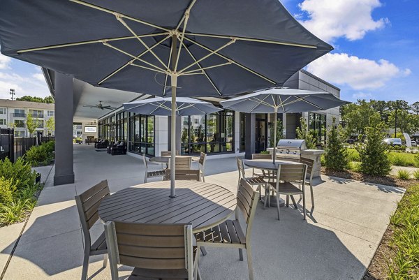 Spacious patio with outdoor seating at Atlantic Springs Apartments, offering luxury living