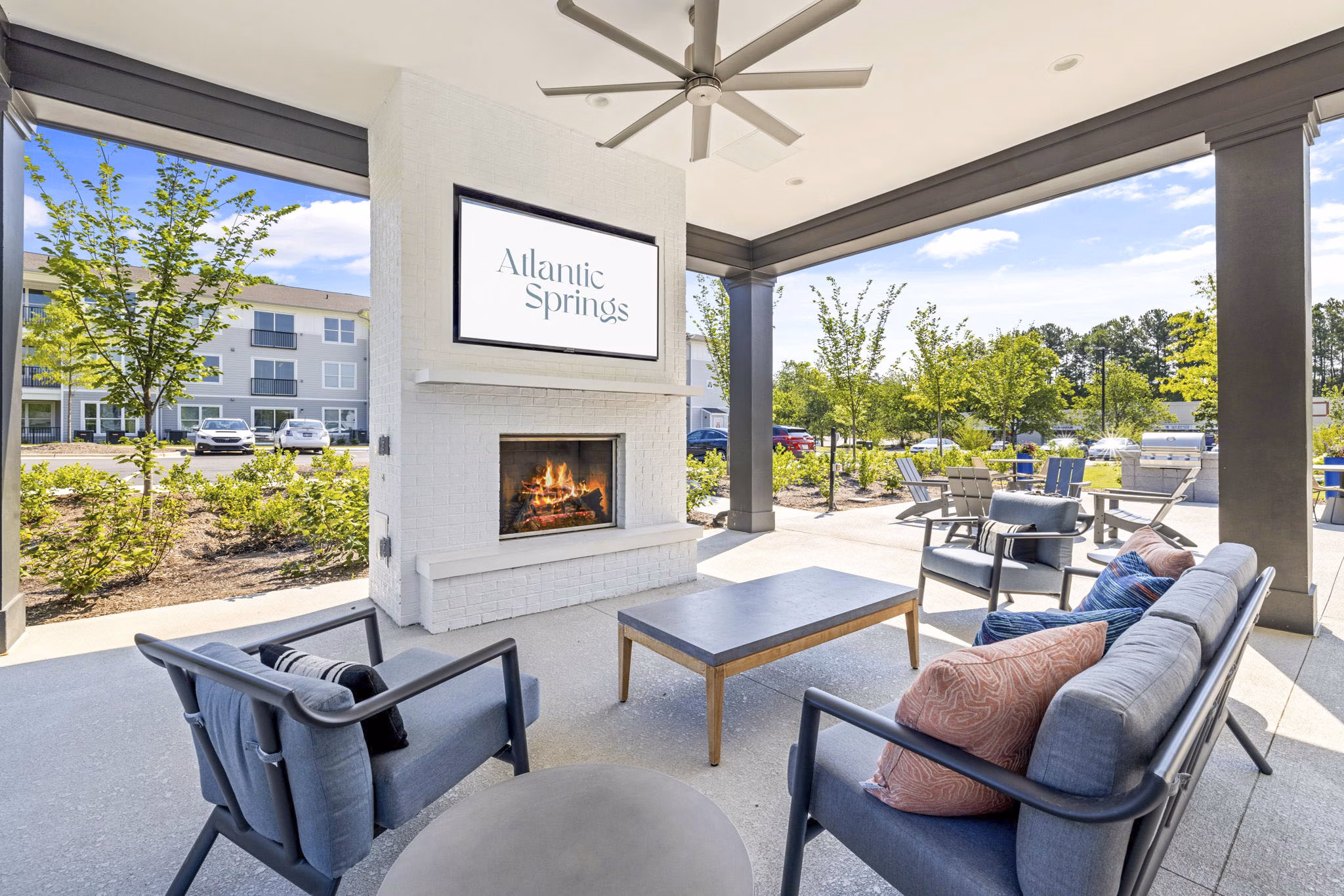 Fire pit and outdoor patio at Atlantic Springs Apartments, perfect for cozy gatherings and relaxing evenings in a luxurious community setting
