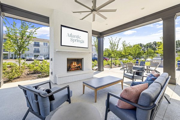 Fire pit and outdoor patio at Atlantic Springs Apartments, perfect for cozy gatherings and relaxing evenings in a luxurious community setting