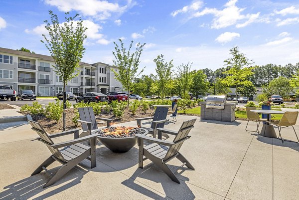 Fire pit and cozy seating area at the patio of Atlantic Springs Apartments, ideal for relaxing outdoors in a luxury setting