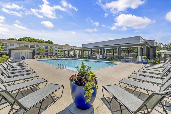 Relaxing pool area with lounge chairs at Atlantic Springs Apartments