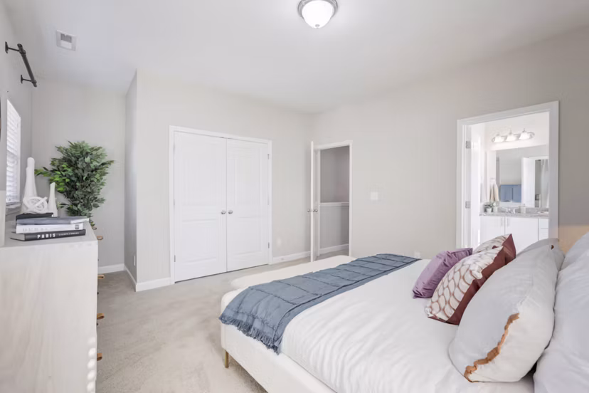 Chic bedroom featuring modern furnishings in Charleston Row Townhomes