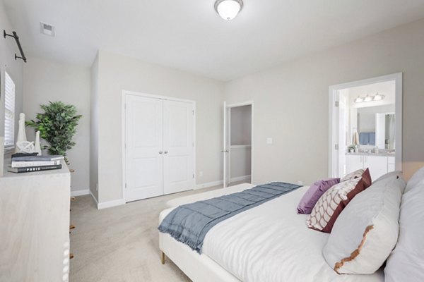 Chic bedroom featuring modern furnishings in Charleston Row Townhomes