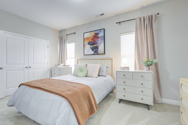 Cozy bedroom with elegant decor in Charleston Row Townhomes, luxury apartments by Greystar
