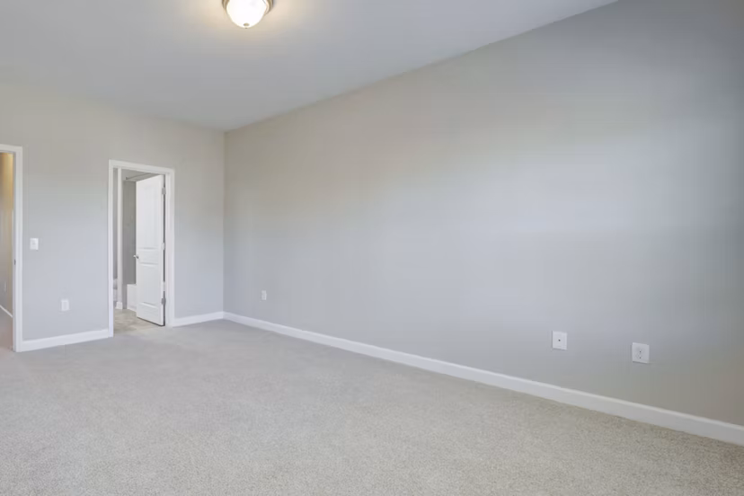 Bedroom with plush bedding and ample natural light at Charleston Row Townhomes