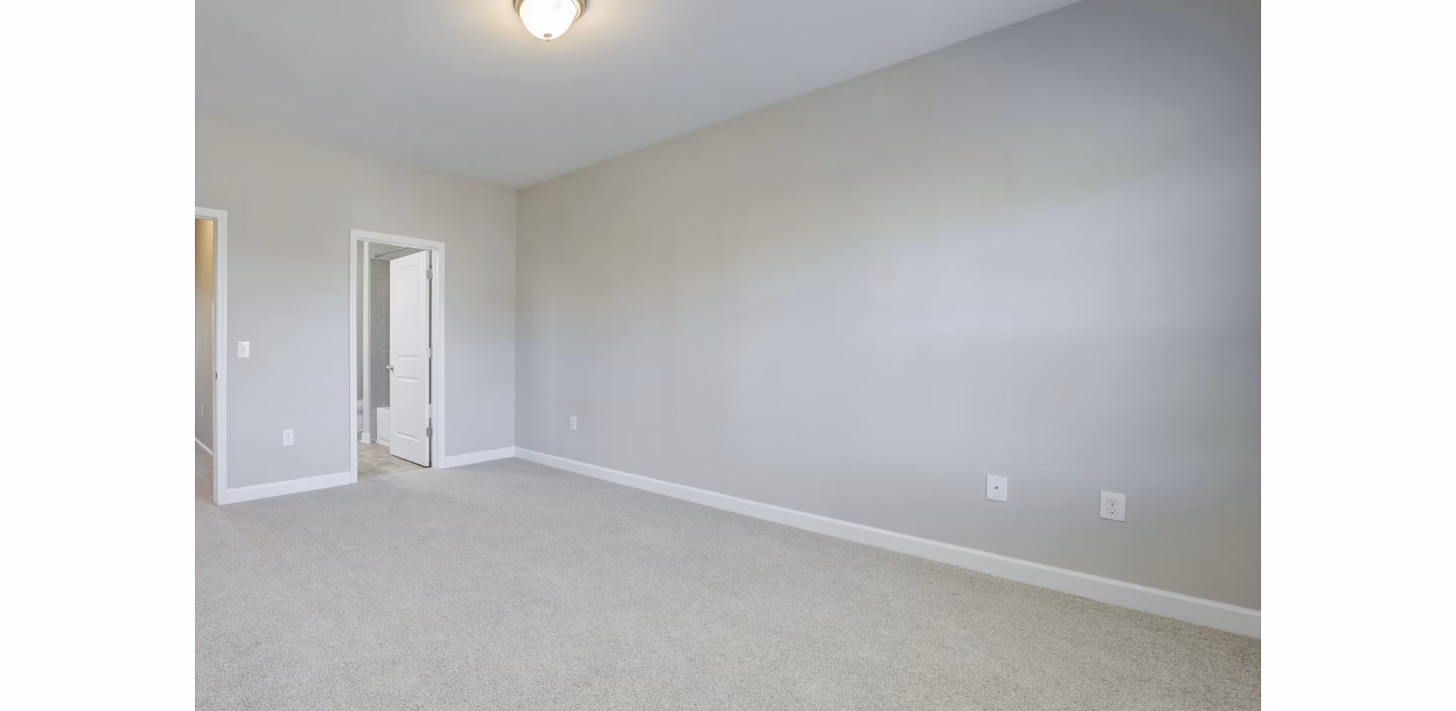Bedroom with plush bedding and ample natural light at Charleston Row Townhomes
