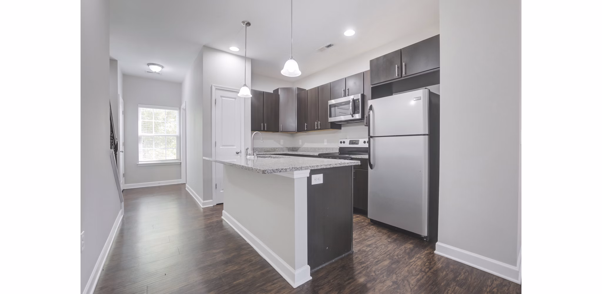 Modern kitchen with stainless steel appliances at Charleston Row Townhomes