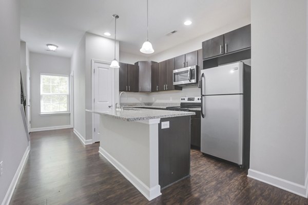 Modern kitchen with stainless steel appliances at Charleston Row Townhomes