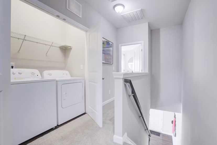 Laundry room featuring modern appliances at Drexler Townhomes in Holbrook Farms