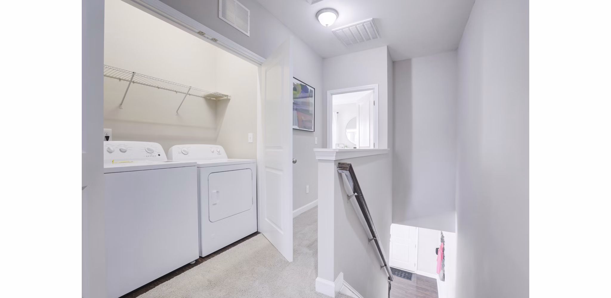 Laundry room featuring modern appliances at Drexler Townhomes in Holbrook Farms