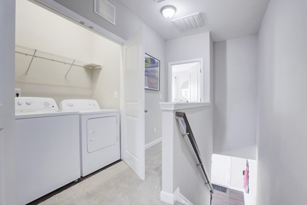Laundry room featuring modern appliances at Drexler Townhomes in Holbrook Farms