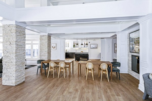 Clubhouse lobby featuring modern decor and seating at The Spoke At McCullough Station Apartments