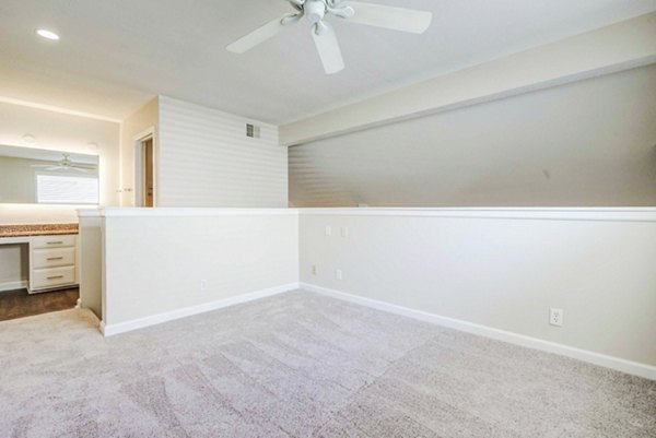 Inviting bedroom with plush bedding and large window in The Spoke at Tyvola Station Apartments