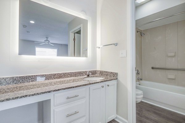 Modern bathroom with sleek fixtures and designer tile at The Spoke at Tyvola Station Apartments