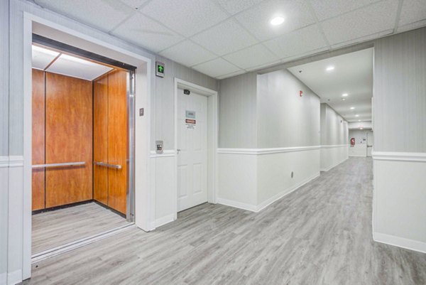 Bright hallway with modern lighting at The Spoke at Tyvola Station Apartments, creating an inviting entrance to luxury living