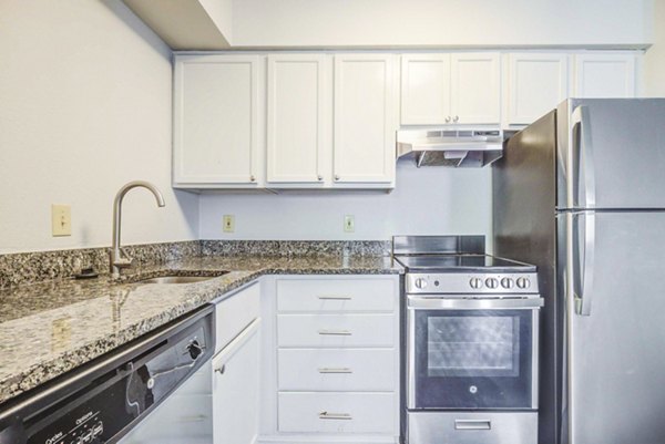 Modern kitchen with stainless steel appliances at The Spoke at Tyvola Station Apartments