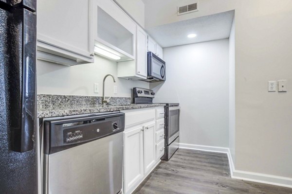 Modern kitchen with stainless steel appliances at The Spoke at Tyvola Station Apartments