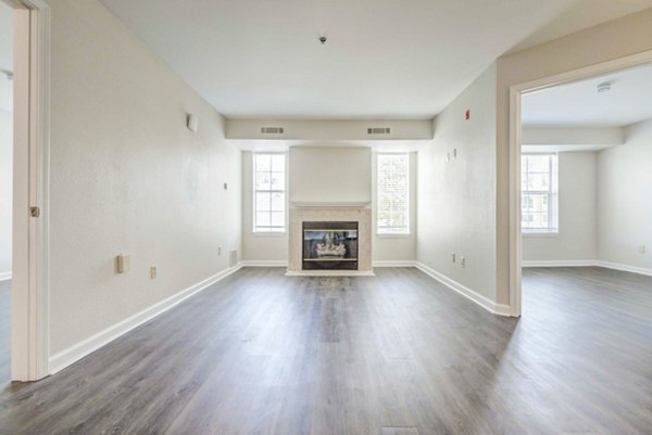 Modern living room with cozy seating and large windows at The Spoke at Tyvola Station Apartments in Charlotte