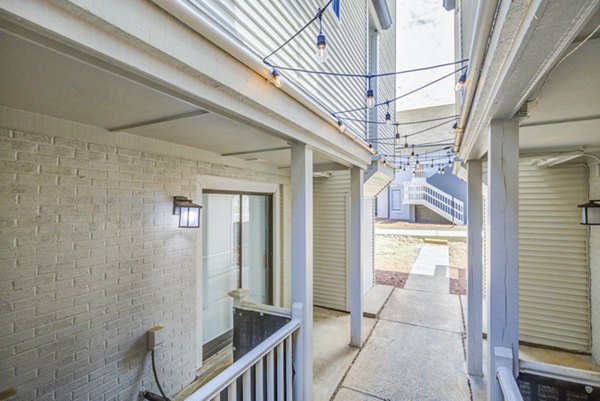 Private patio with stylish seating and garden views at The Spoke at Tyvola Station Apartments