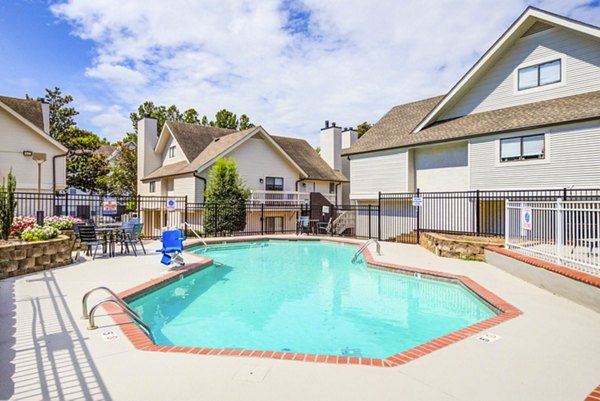 Outdoor pool at The Spoke at Tyvola Station Apartments with poolside lounging, offering luxury leisure experience