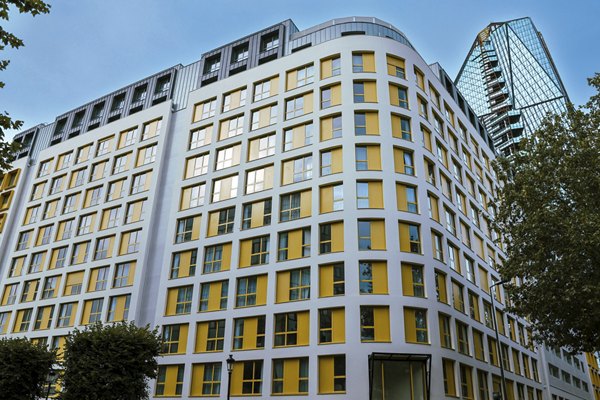 Exterior view of a modern building with yellow and white facade.