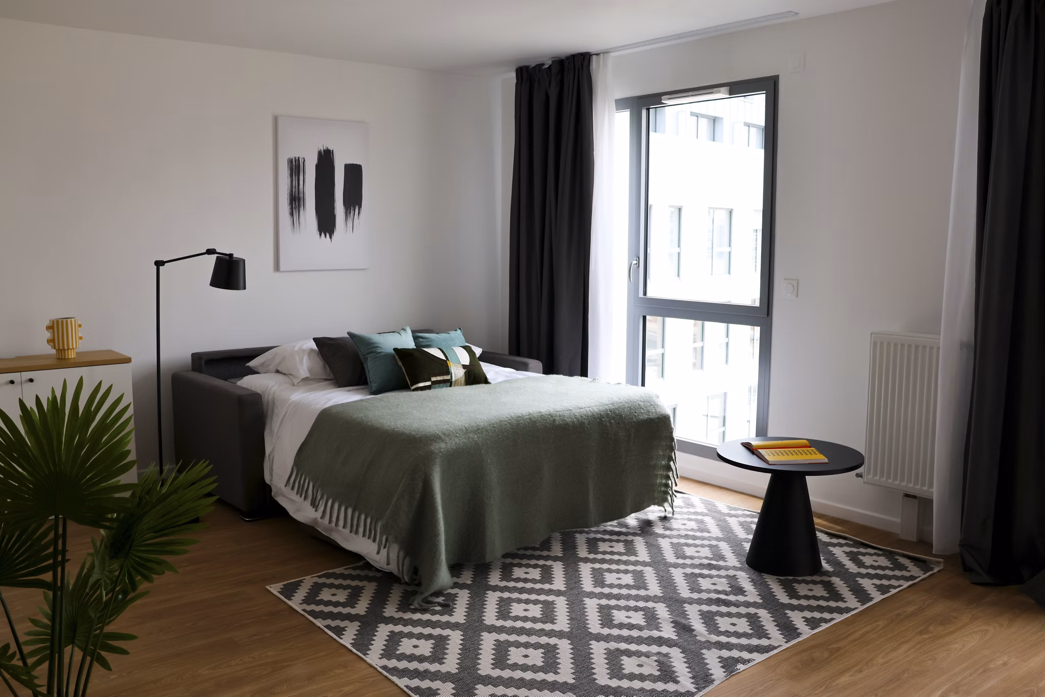Bright bedroom with a large window, double bed, and modern decor.