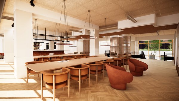 Spacious common area with long tables, chairs, and modern lighting.