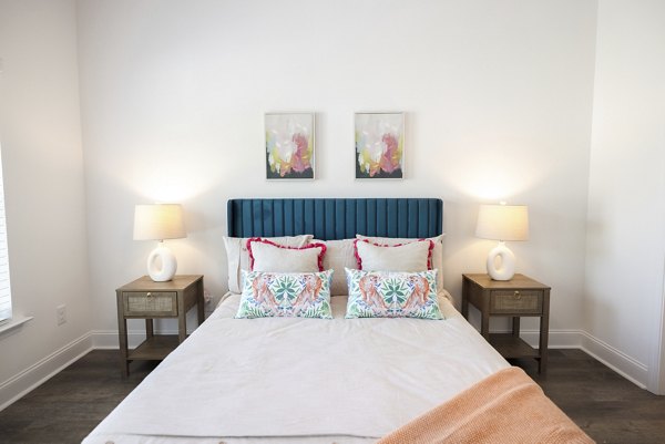 Spacious bedroom with elegant decor at Reve on the Creek Apartments, offering luxury living experiences
