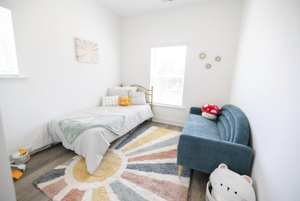 Spacious bedroom with modern decor at Reve on the Creek Apartments
