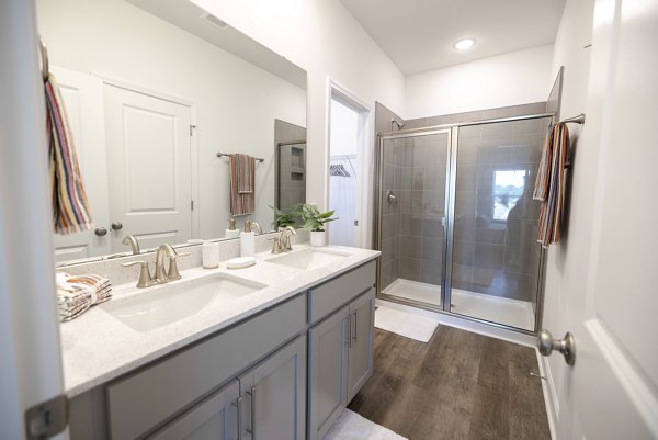 Modern bathroom with sleek fixtures at Reve on the Creek Apartments