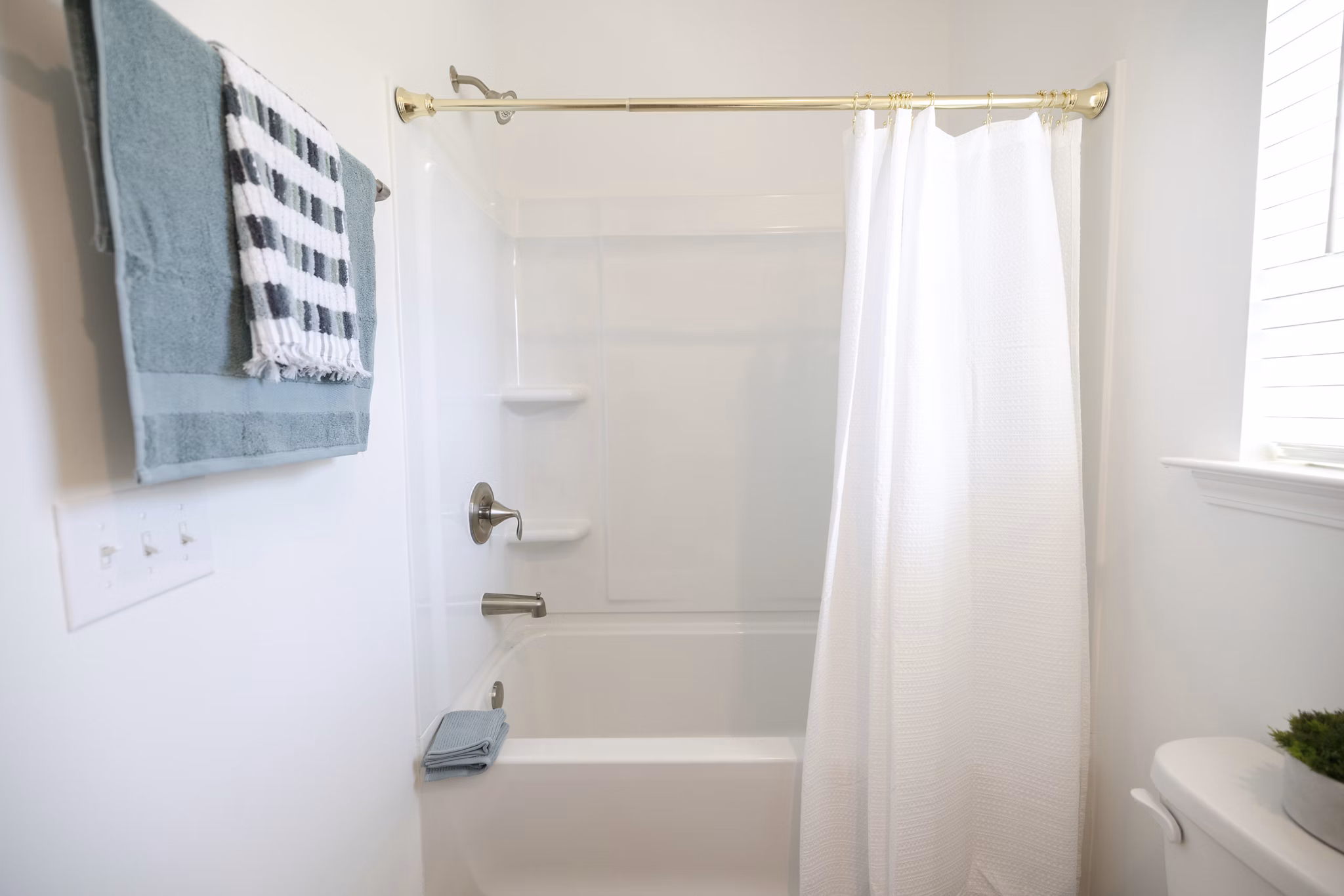 Modern bathroom with sleek fixtures at Reve on the Creek Apartments