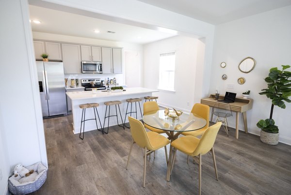 Elegant dining room with modern decor and large windows in Reve on the Creek Apartments