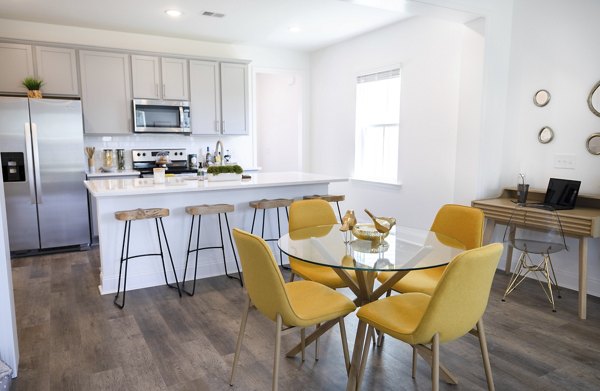 Dining room with sleek furnishings at Reve on the Creek Apartments, ideal for social gatherings in a luxury setting