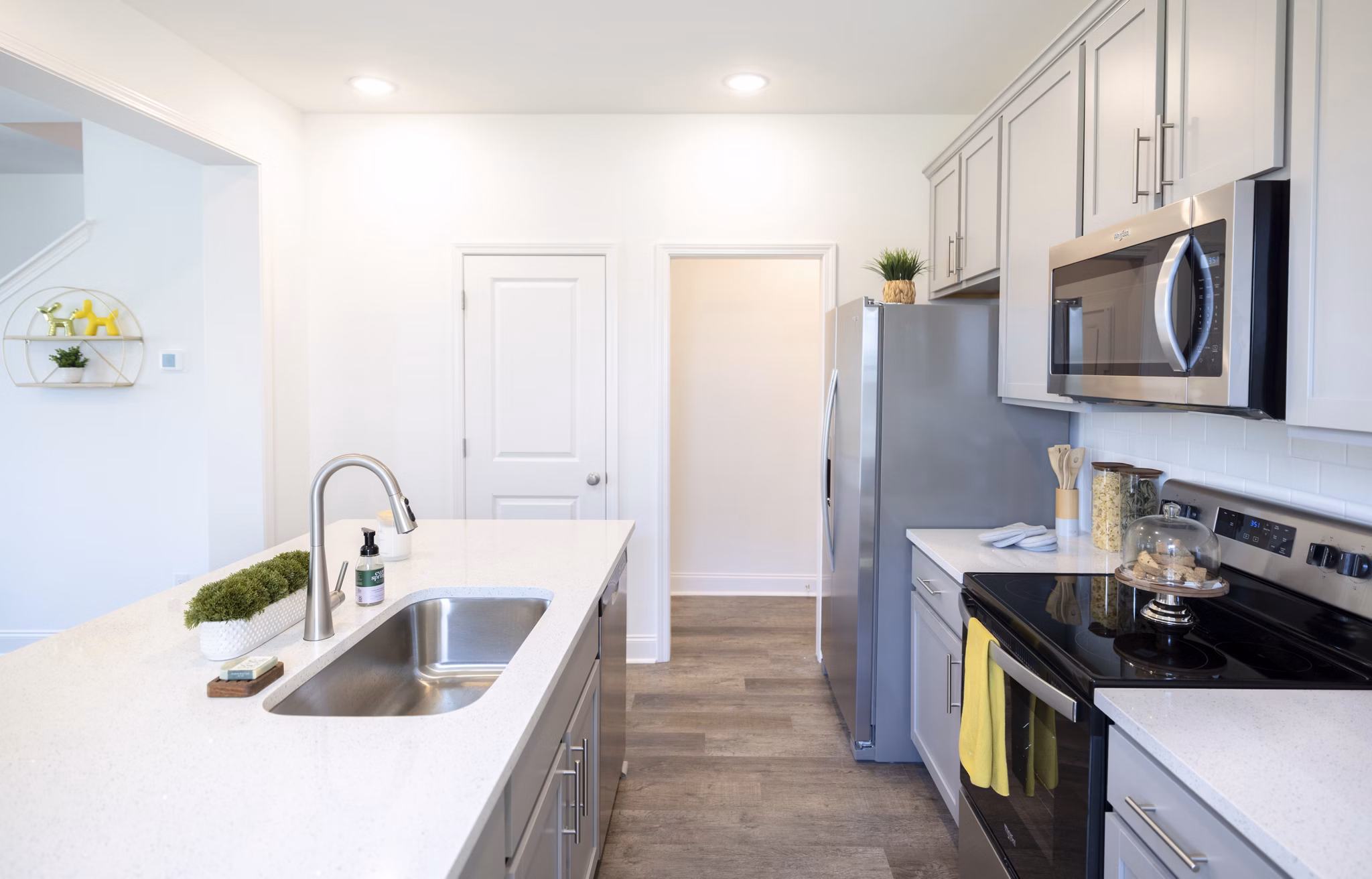 Modern kitchen with stainless steel appliances at Reve on the Creek Apartments luxury apartments in a serene setting