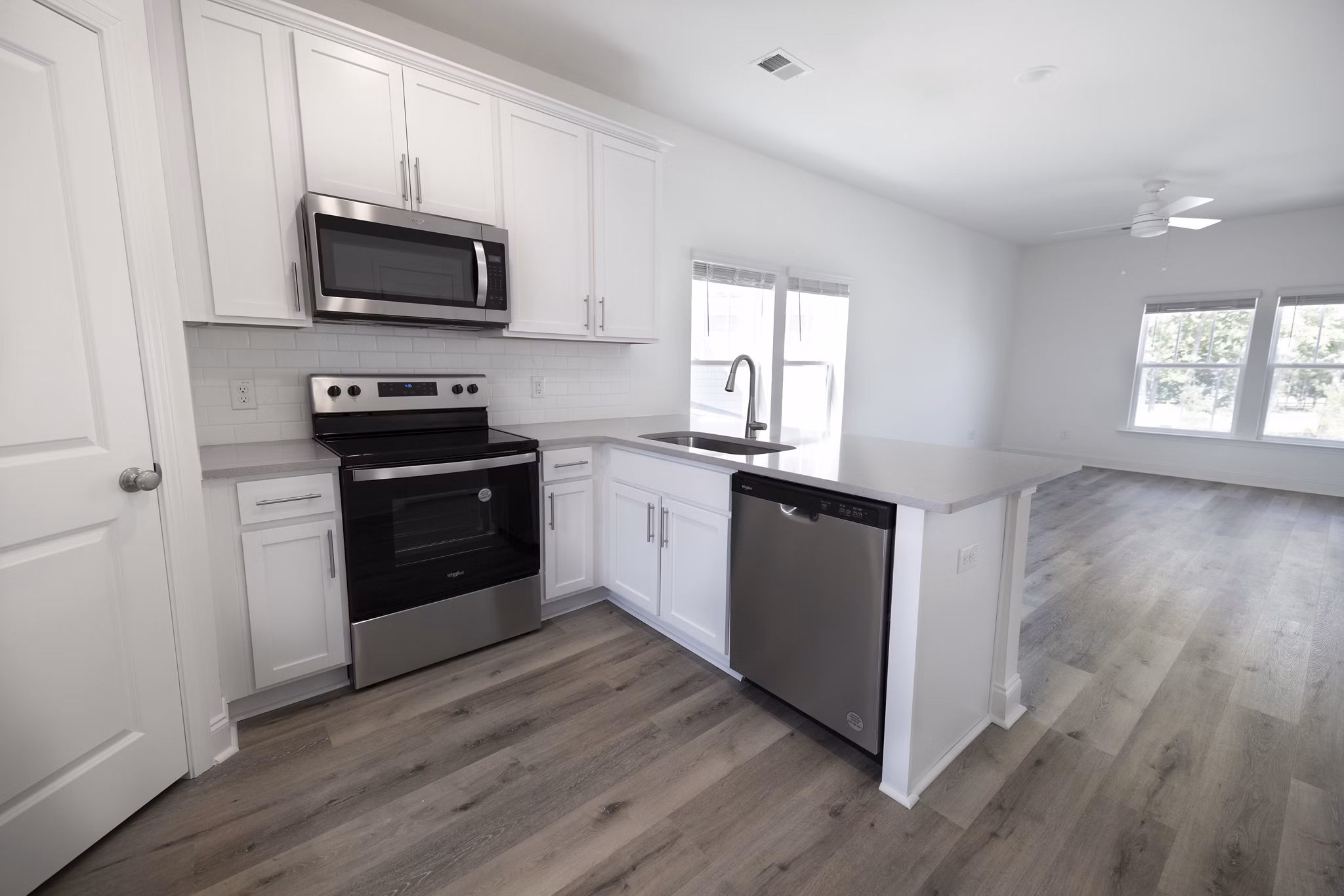 Spacious kitchen with modern appliances at Reve on the Creek Apartments, perfect for luxury living