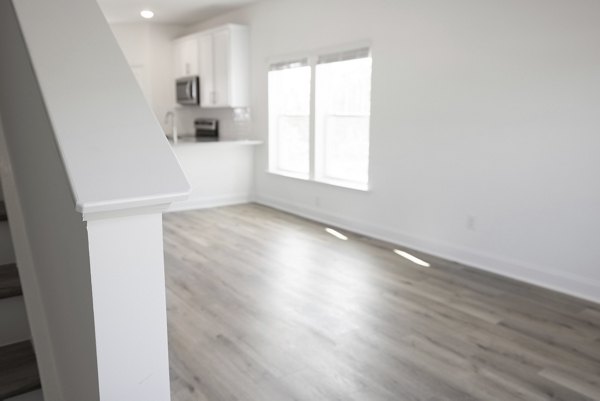Elegant living room with modern furnishings at Reve on the Creek Apartments, showcasing spacious design and luxury features