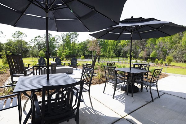 Fire pit on patio at Reve on the Creek: Modern outdoor amenity for residents to enjoy cozy evenings and social gatherings, enhancing luxury apartment living