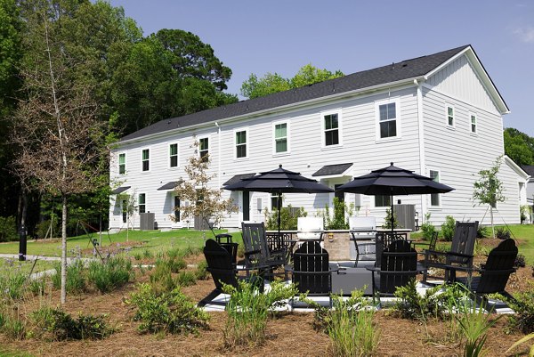 Outdoor fire pit and grill area on patio at Reve on the Creek Apartments
