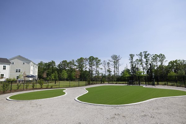 Practice putting green at Reve on the Creek Apartments offering luxurious leisure activities for residents