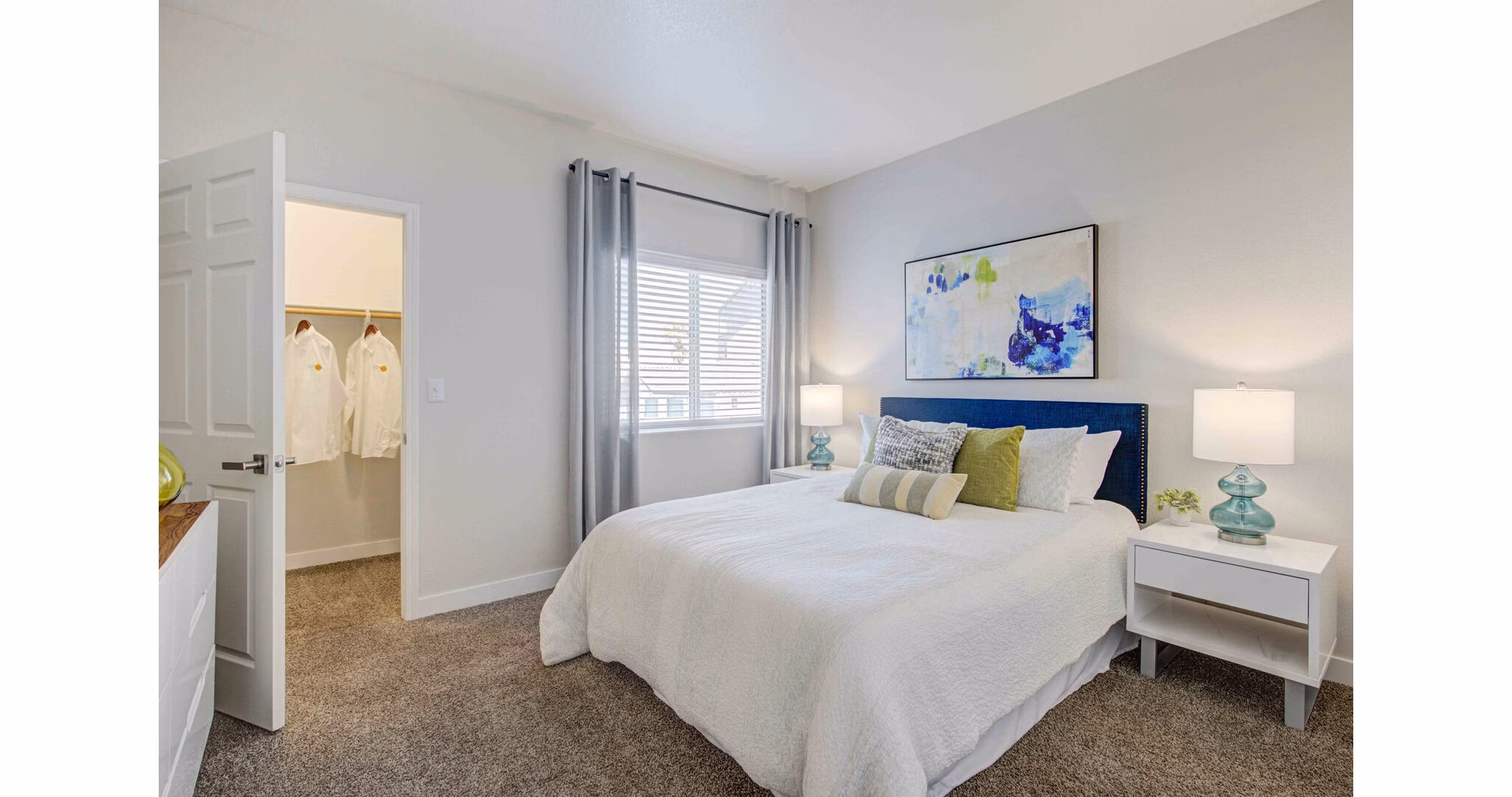 Spacious bedroom featuring modern decor and natural light at Citron Apartments