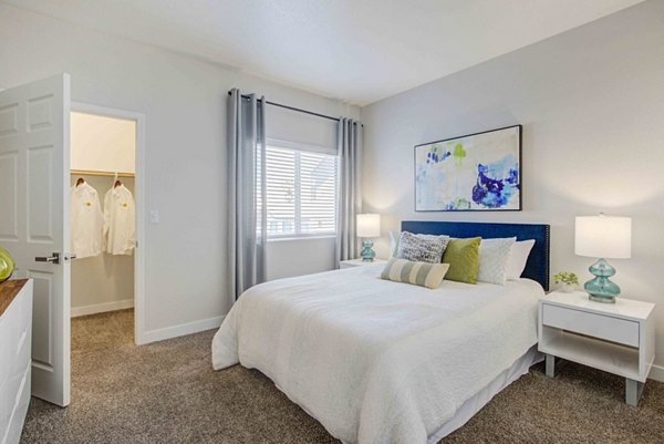 Spacious bedroom featuring modern decor and natural light at Citron Apartments